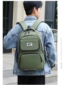 Army green nylon backpack for business or travel shown on model in outdoor setting
