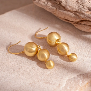 Elegant gold matte metal triple sphere drop earrings with minimalist geometric design