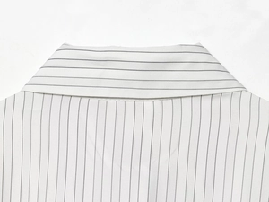 Close-up of black and white pinstripe shirt collar with premium fabric texture