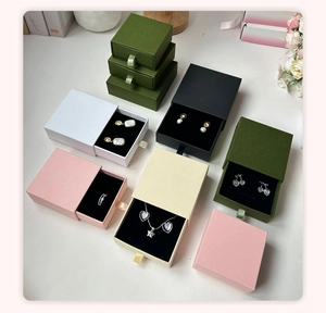 Detailed top view of drawer-style jewelry gift boxes in various colors with ribbon pulls