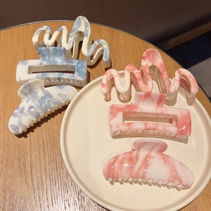 Ink marble pattern large hair claw clips set in wave and rectangular shapes on ceramic tray