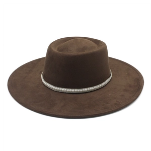 Detail view of brown faux suede wide brim fedora hat featuring elegant pearl decorative band