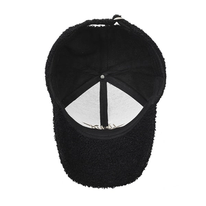 Inner view of black faux lamb wool baseball cap with thick lining and gold embroidery