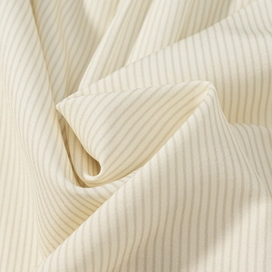 Close-up of the cream striped fabric showing detailed texture and soft draped folds