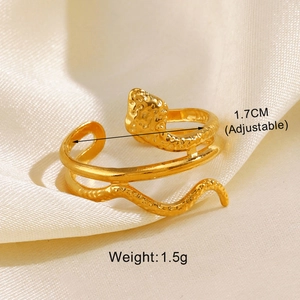 Détail d'une bague serpent dorée ajustable sur tissu en soie avec taille de 1,7 cm
