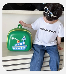 Detailed close-up of a green EVA hard shell children backpack with 3D cartoon boat design