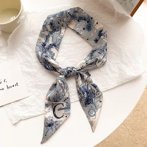 Blue and white silk hair scarf with celestial vintage print tied in a bow