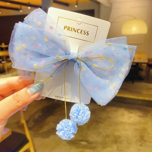 Light blue mesh bow hair clip with colorful dots and soft pom-pom charms for girls