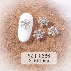 Macro shot of silver snowflake nail charms with rhinestones measuring 8.5x10mm size