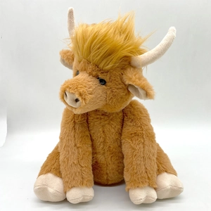 Macro detail of the fluffy brown fur and curved horns on this Highland Cow plush toy
