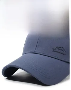 Detail of navy blue baseball cap showing firm brim and mountain peak embroidery