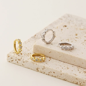 Detailed view of S925 silver star hoop earrings in gold and silver with zircon inlays
