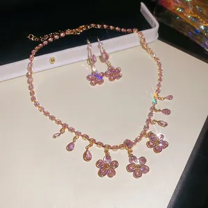 Detailed macro view of pink zircon flower jewelry set with elegant droplet tassels