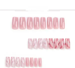 Detailed view of pink press-on nails with marble patterns and gold foil flakes