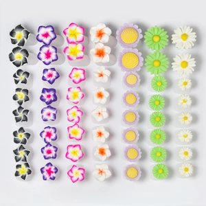 Flat lay of 42 colorful silicone toe separators in daisy and floral shapes for nail art