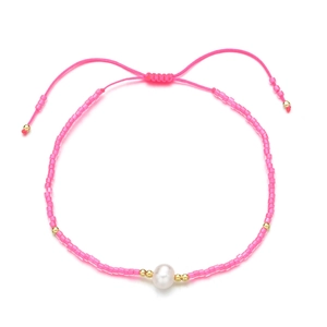 Detail of pink seed bead bracelet featuring a freshwater pearl and adjustable cord