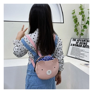 Pink bear-shaped backpack for kids featuring a drawstring closure and adjustable straps