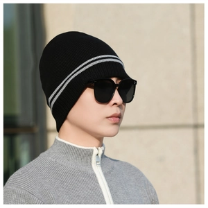 Close-up of black knitted beanie with white stripes and thick thermal lining material