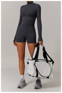 Detail of grey athletic set featuring a zip-up long sleeve top and high-waist shorts