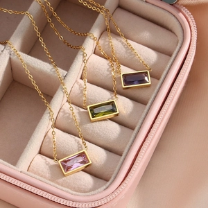 Detailed view of three rectangular gemstone pendants in a pink luxury jewelry box