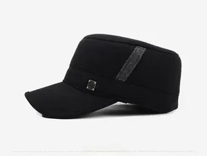 Side view of black outdoor flat top cap with wool texture and metal badge detail