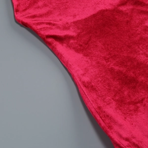 Close-up of elegant red velvet fabric showing soft texture and luxurious glossy finish