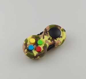 Close-up of a camouflage fidget pad with colorful buttons and joystick on white backdrop