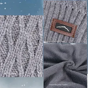 Winter knitted beanie hat with fleece lining and leather label in gray ripple pattern