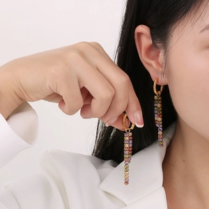 Rainbow rhinestone tassel drop earrings in gold plating worn by a model