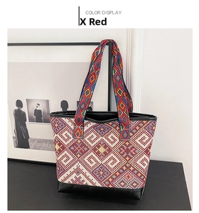 Macro shot of ethnic embroidery patterns and leather bottom on large canvas tote bag