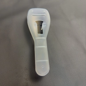 Close-up of translucent white matte storage case for portable razors on a leather surface