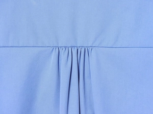Gros plan détaillé de l'empiècement arrière plissé en popeline et coutures de chemise