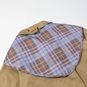 Detail of khaki jacket showing plaid pattern stitching and high-quality button craft