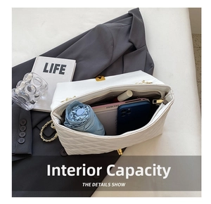 Detailed interior view of white quilted crossbody bag showing large capacity for essentials