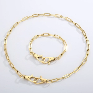 Detail of golden stainless steel paperclip chain necklace and bracelet set with lobster clasps