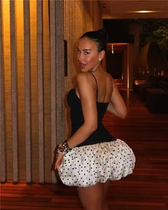 Side view of sexy deep V-neck strap dress with white polka dot bubble skirt