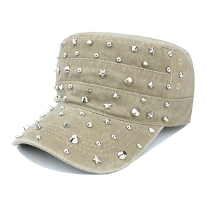 Detail of khaki cadet cap with star and pyramid metal studs on washed canvas