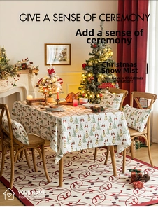 Detailed view of Christmas snowman and tree pattern on festive tablecloth and chair covers