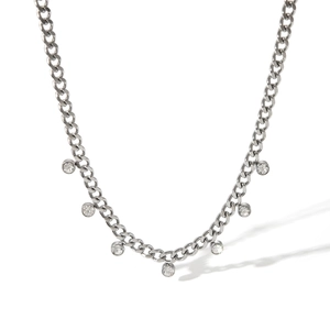 Detail of silver Cuban chain necklace with seven dangling round clear zircon stones