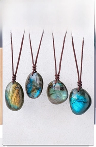 Macro detail of natural labradorite pendants showcasing vibrant blue and green fire flashes