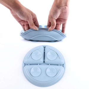 Detail of blue silicone baby plate showing high flexibility and bottom suction cups