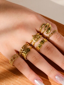 Detail of 6-piece 18k gold-plated ring set featuring leaf, heart, and chain textures