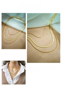 Close-up of layered gold titanium snake chains with lobster clasp and adjustable links