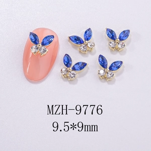 Detail of blue marquise rhinestone butterfly nail art charms with golden metal base