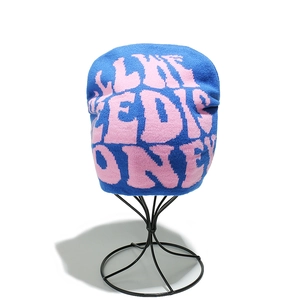 Close-up of knit texture and pink jacquard lettering on royal blue Y2K beanie