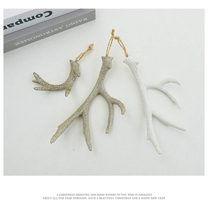 Detail of resin elk antler ornaments with glitter finish and jute ropes for Christmas