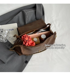 Macro view of spacious brown leather tote interior showing storage for daily essentials