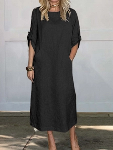 Detailed texture of loose black cotton linen maxi dress with short sleeves and round neck