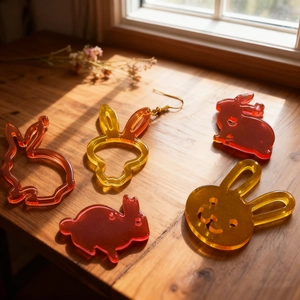 Handmade rabbit and cat silhouette resin jewelry charms with gold glitter gradient finish