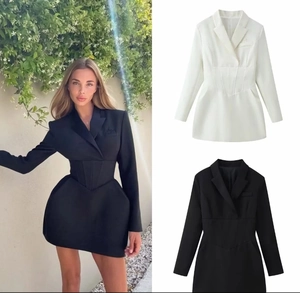 Vista detallada de vestido tipo blazer entallado con cuello en V y falda plisada evasé